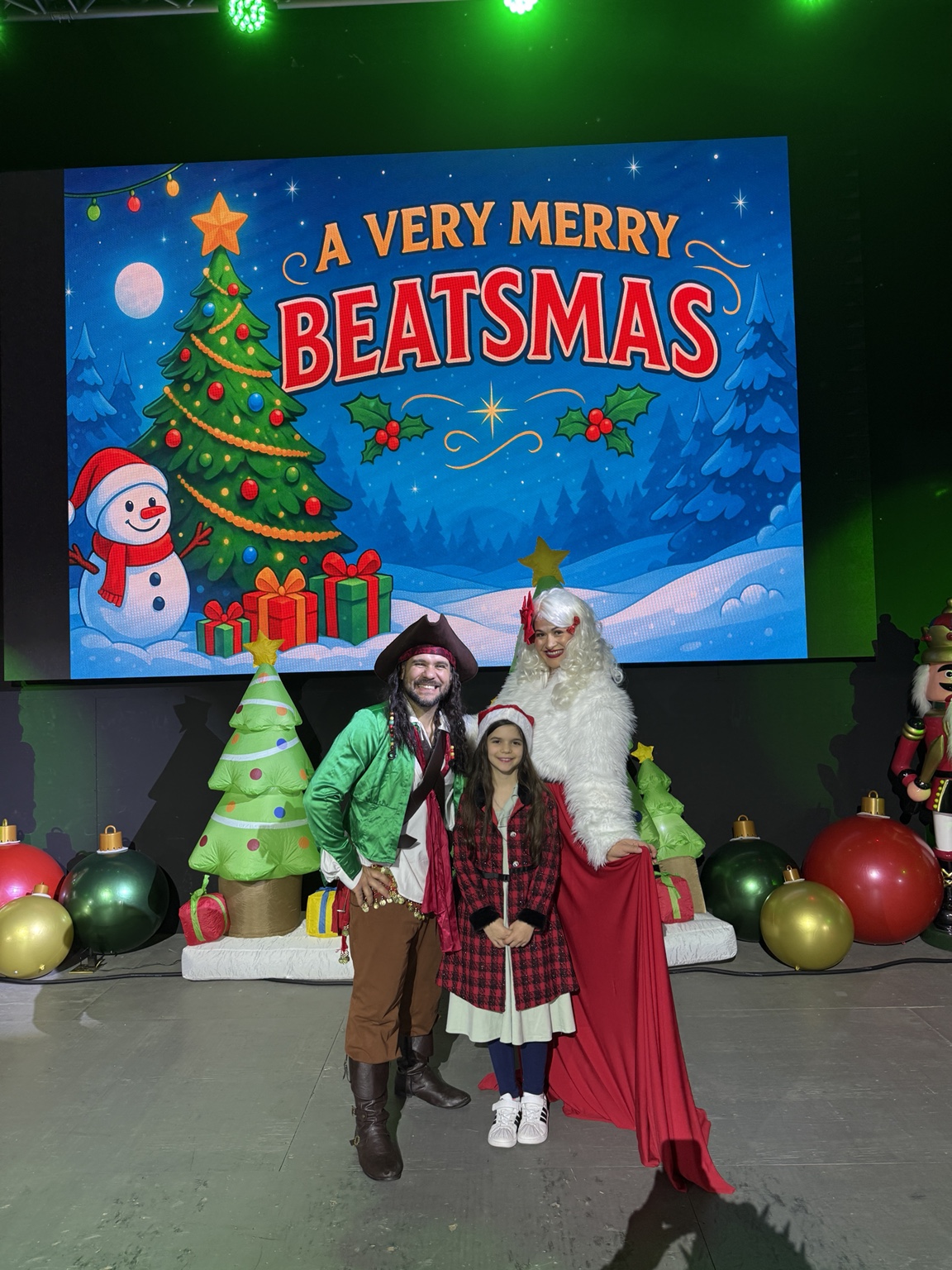 Beauty & The Beats performers with a young guest at A Very Merry Beatsmas