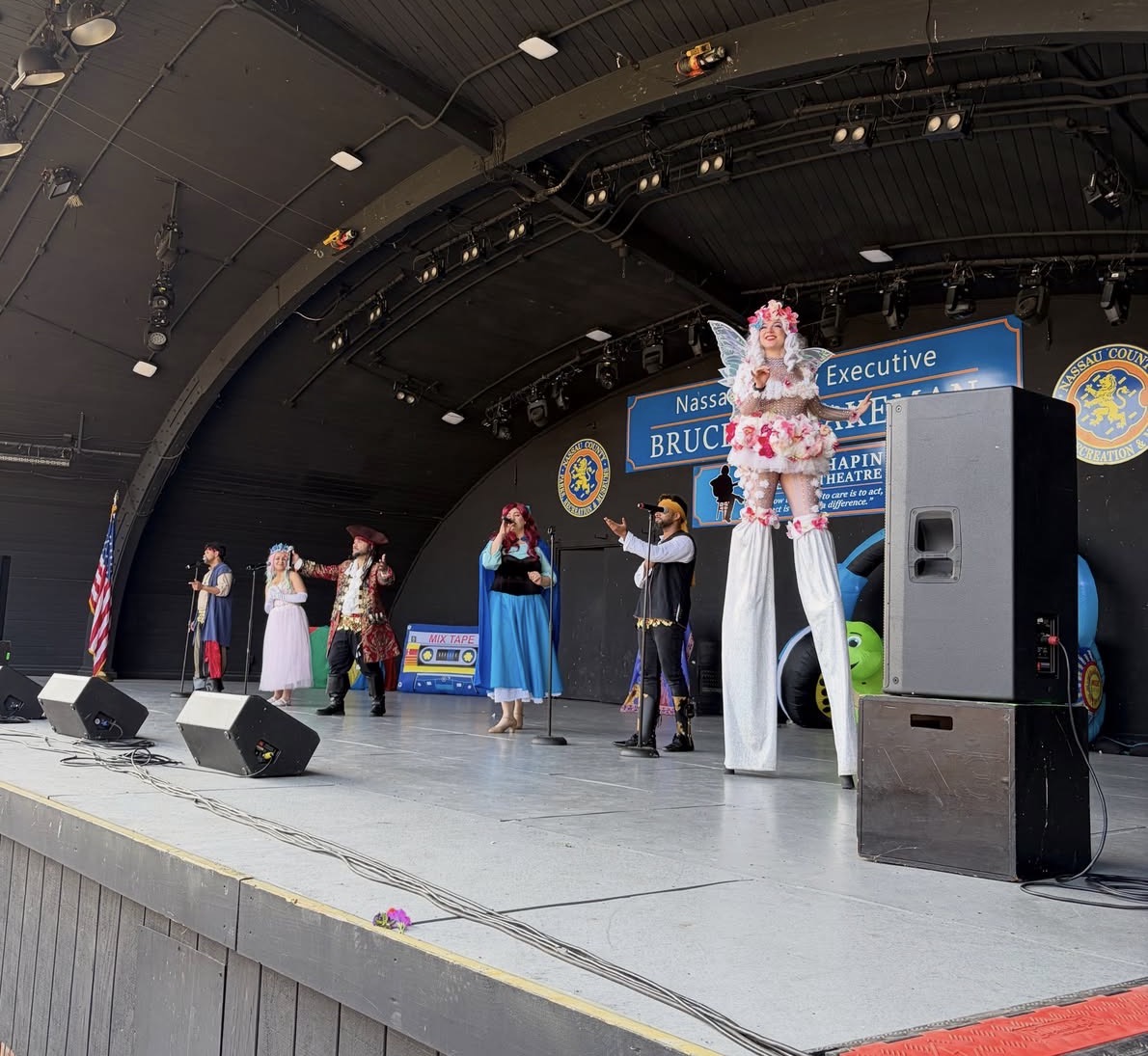 Beauty & The Beats cast performing together on an outdoor stage
