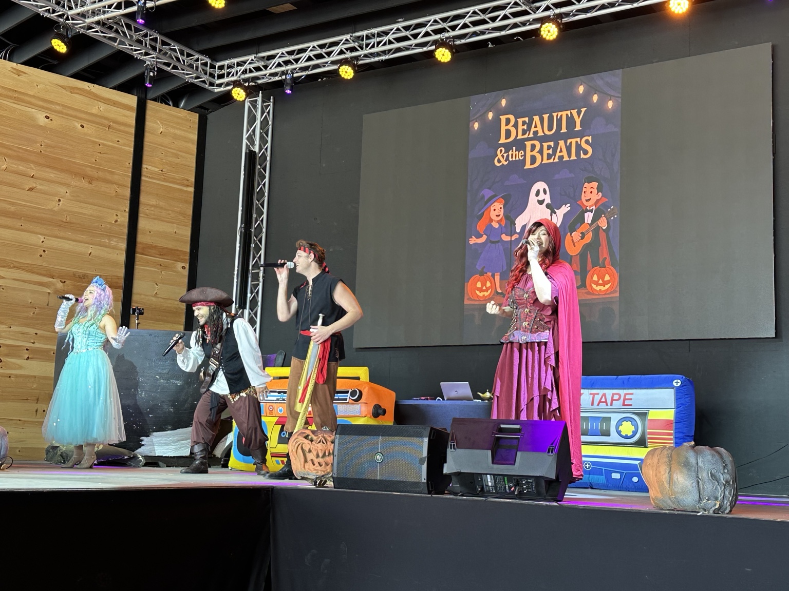 Beauty & The Beats cast performing a Halloween show on stage