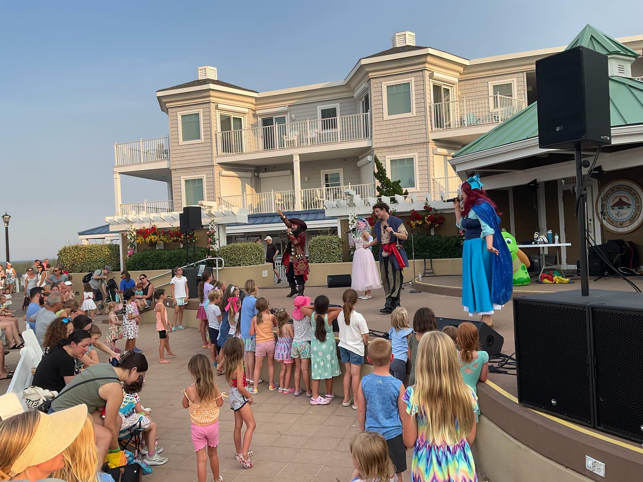 Beauty & The Beats performers singing for a crowd of families outdoors
