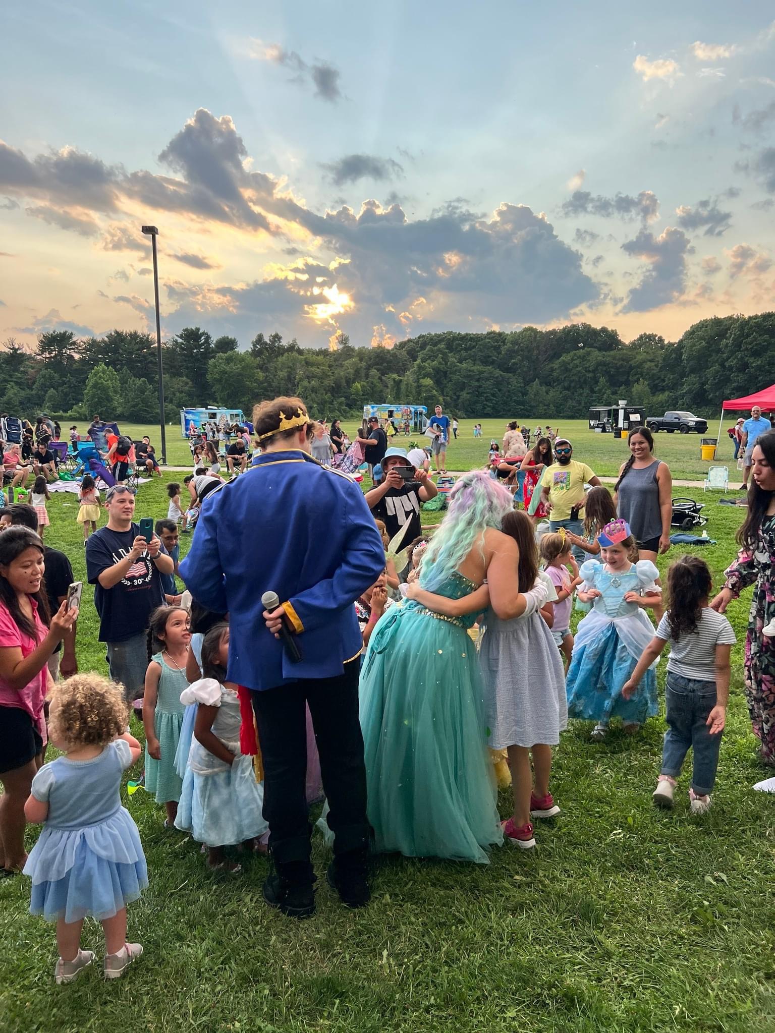 A prince and princess meeting children at an outdoor show