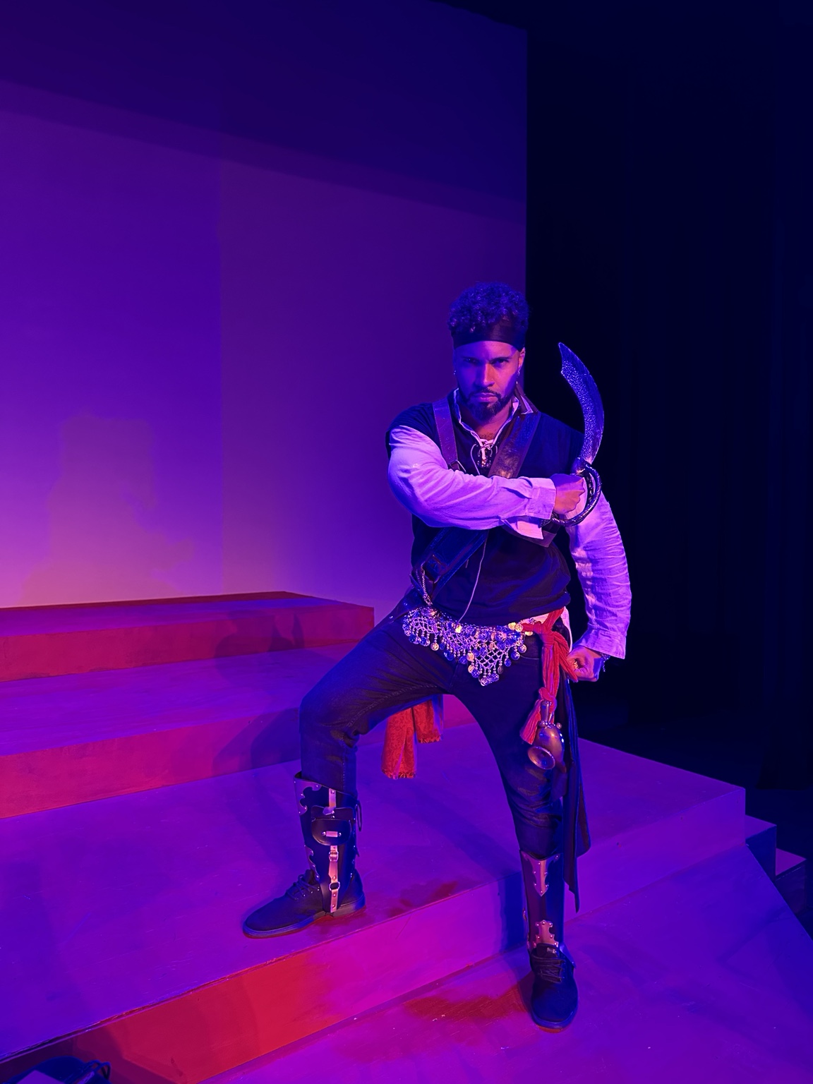Pirate performer on stage under purple light